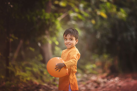 Boy with orange balloon