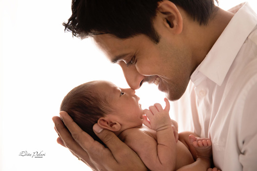 dad and newborn son - backlit picture