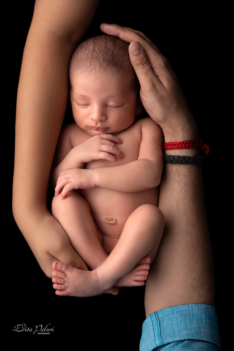 newborn baby in parents hands
