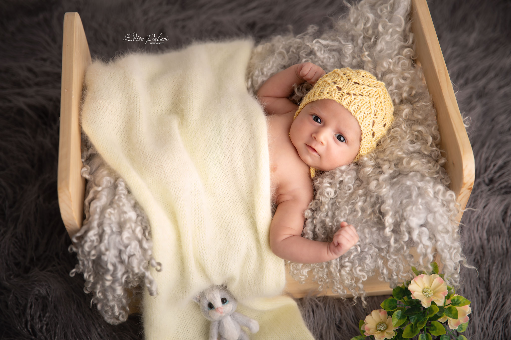 1 month Baby photo in tiny bed and yellow wrap in Pune