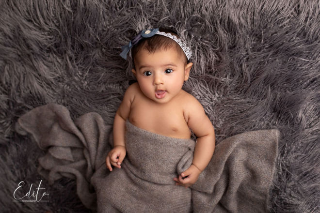 4 month baby girl photo shoot on grey fur and woolen wrap