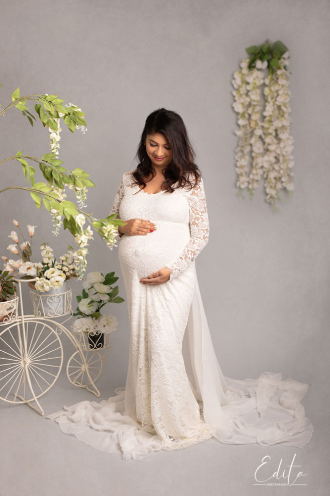Indian Maternity shoot in white outfit surrounded with white flowers