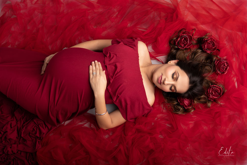 Aerial maternity photo in red gown