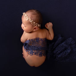 Newborn baby posing on bean bag clicked from top