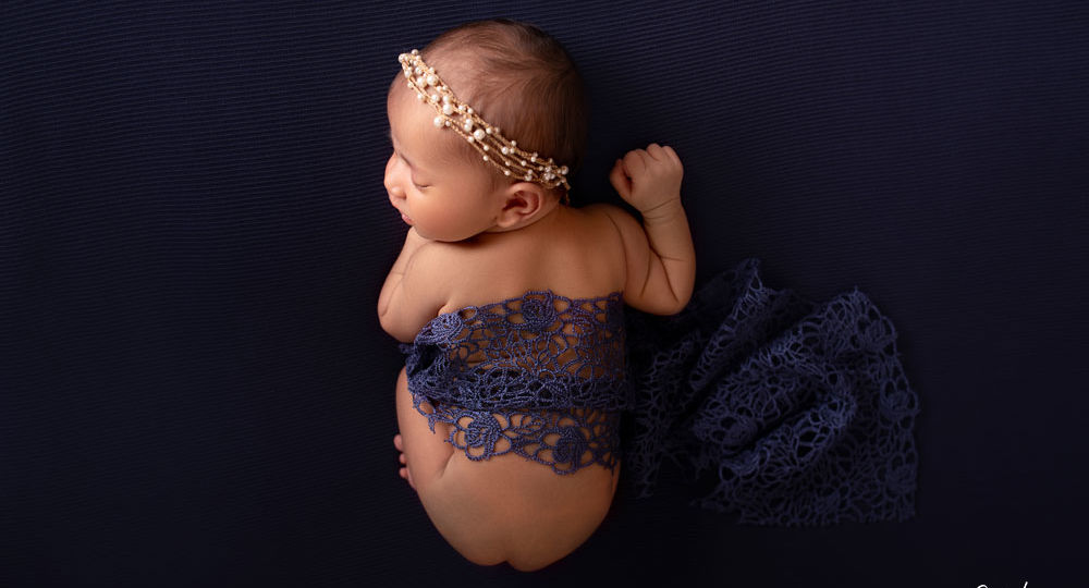 Newborn baby posing on bean bag clicked from top