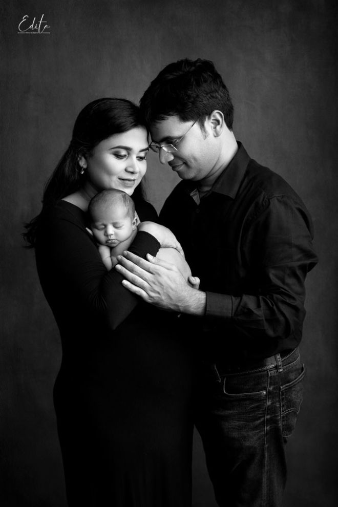 newborn girl photo with parents in black and white
