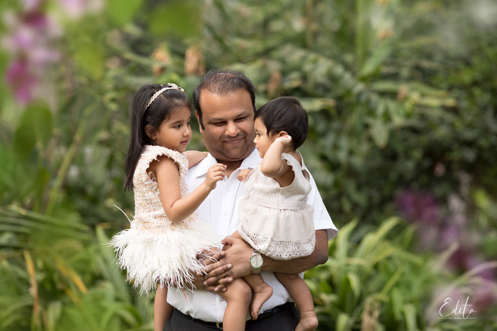 Dad with 2 daughter photo in garden