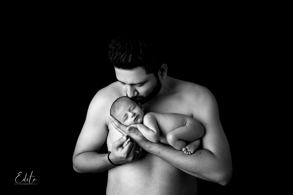 Father shirtless with newborn baby boy photo