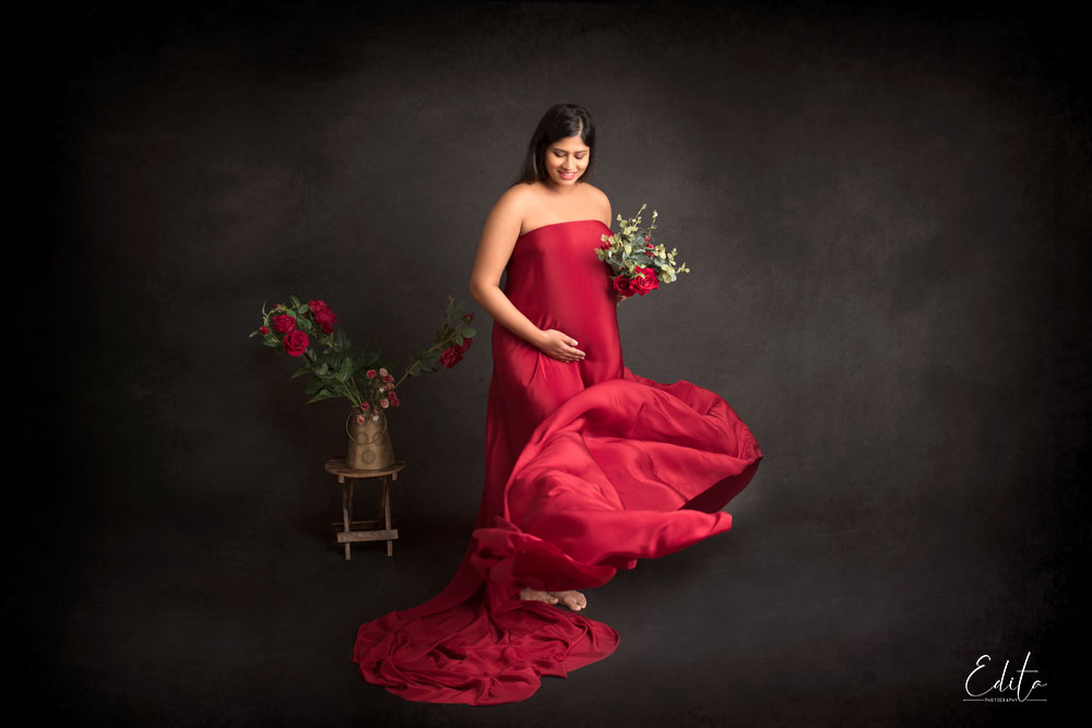 Pregnancy photographer Pune red fabric tossing on black background