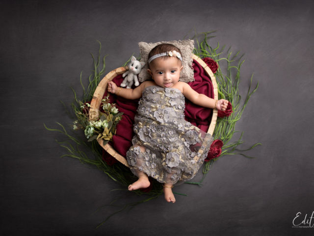 3 month baby girl in heart shaped bowl wrapped in grey wrap by Edita Photography