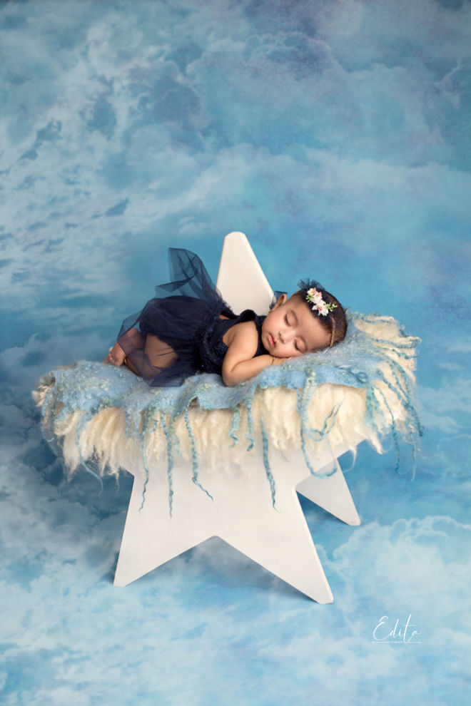 3 month baby girl in navy blue dress on the star prop
