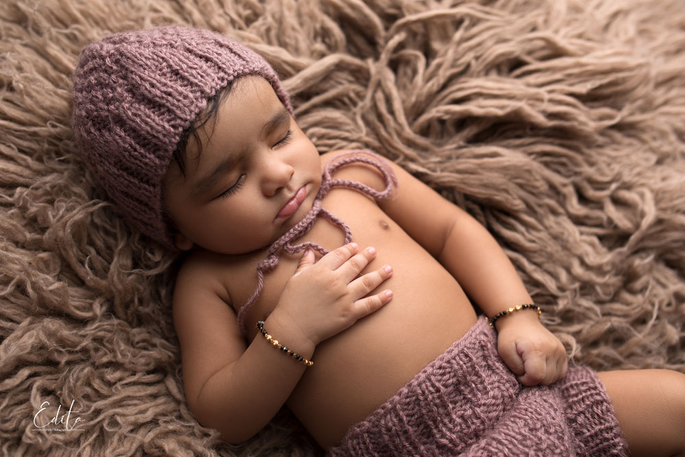 Sleeping 4 month baby boy photo on brown flokati