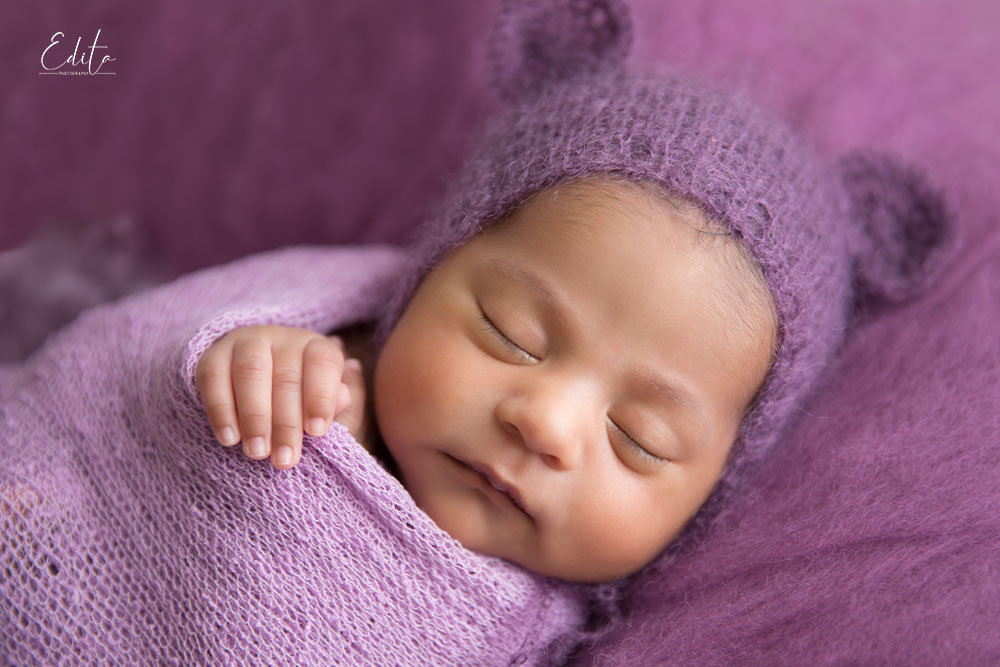 Newborn indian baby milestone photo shoot  photo shoot in purple setup close up