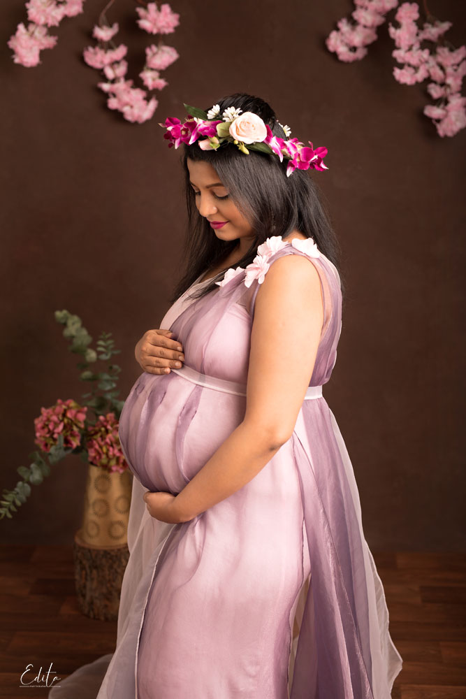 Pregnancy photo in pink dress. mothers day