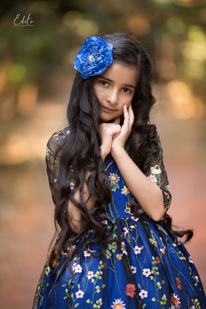 Children photo shoot in the forest, 9 year girl in blue gorgeous dress with flowers