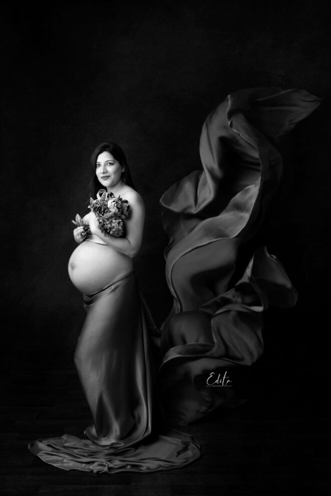 Black and white pregnancy belly photoshoot fine art fabric tossing flying by Edita photography in Pune