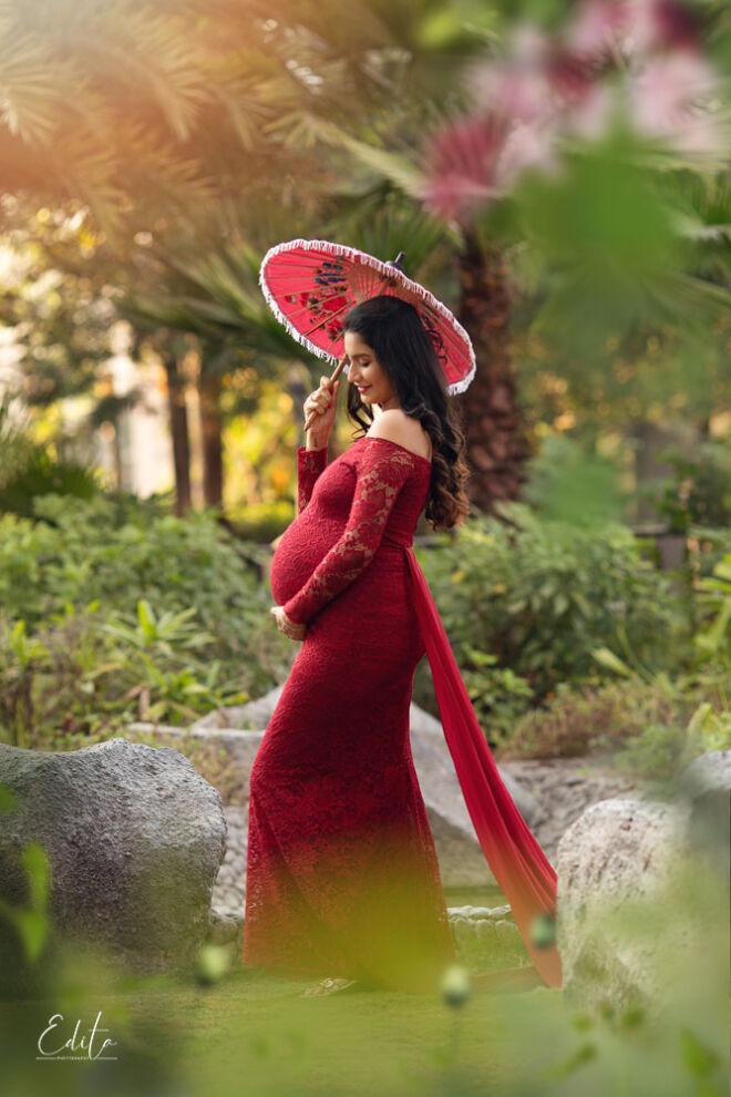 Pregnancy photo in red gown and umbrella