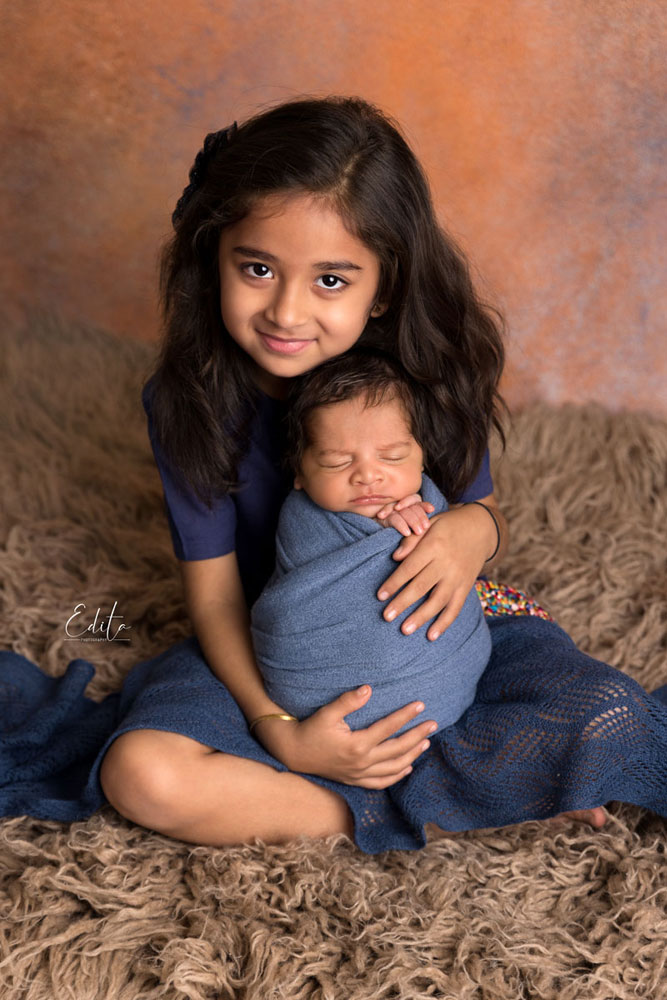 Big sister with her newborn brother photo