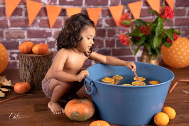 Toddler boy photos in autumn pumpkin setup