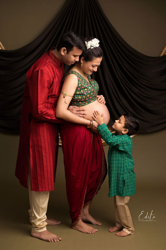 Couple expecting their second baby photo in indian traditional outfits