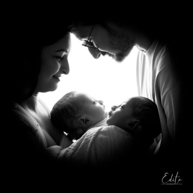 Backlit family portrait with newborn twins babies